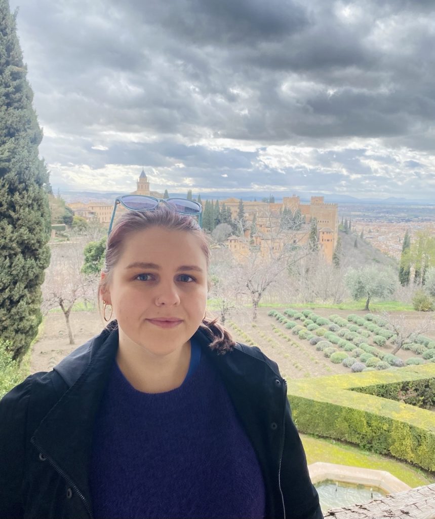 lithuanian girl and alhambra palace in granada spain in winter time in the backround, granada alhambra rumai parkas ispanijoje ziemos metu